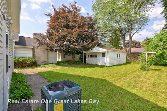 2249 N Clinton St, Saginaw, MI 48602 - view of green lawn with an outdoor structure and a garage