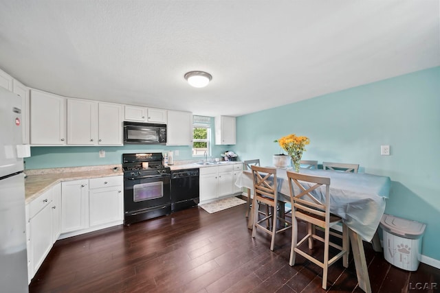 424 W Summit St, Adrian, MI 49221 - kitchen featuring black appliances, white cabinetry, dark wood-type flooring, and a textured ceiling