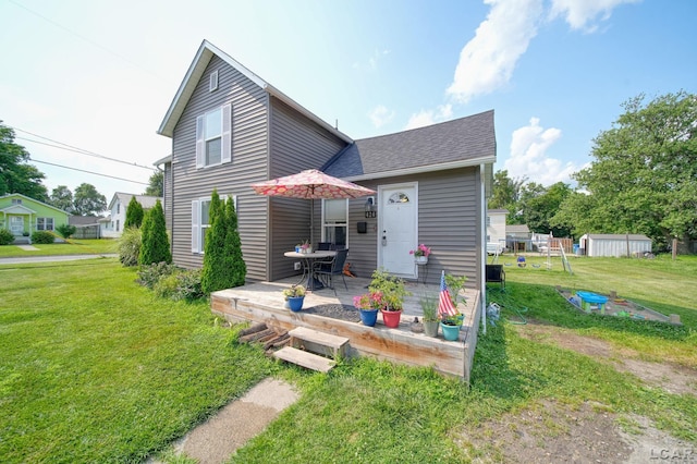 424 W Summit St, Adrian, MI 49221 - back of house with a shingled roof, a yard, and a patio