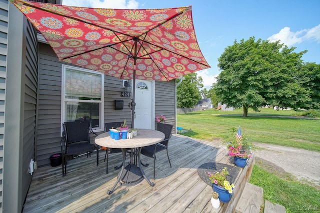 424 W Summit St, Adrian, MI 49221 - wooden deck with outdoor dining space and a lawn