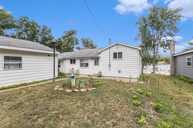 52 S Emerson Lake Dr, Branch, MI 49402 - rear view of property featuring a lawn