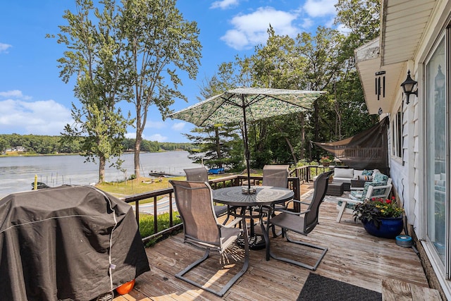 52 S Emerson Lake Dr, Branch, MI 49402 - wooden deck featuring grilling area, a water view, outdoor dining space, and an outdoor living space