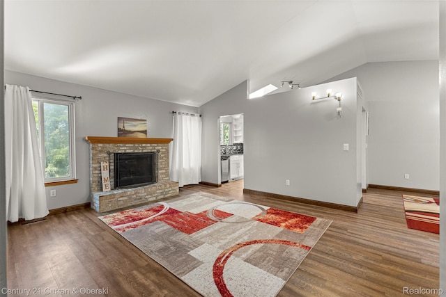 1786 Daisy Ln, Westland, MI 48186 - unfurnished living room with vaulted ceiling, wood finished floors, and a fireplace