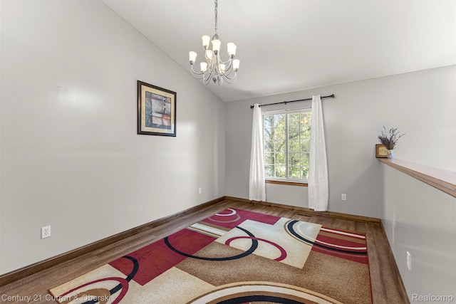 1786 Daisy Ln, Westland, MI 48186 - empty room with a chandelier, wood finished floors, and lofted ceiling