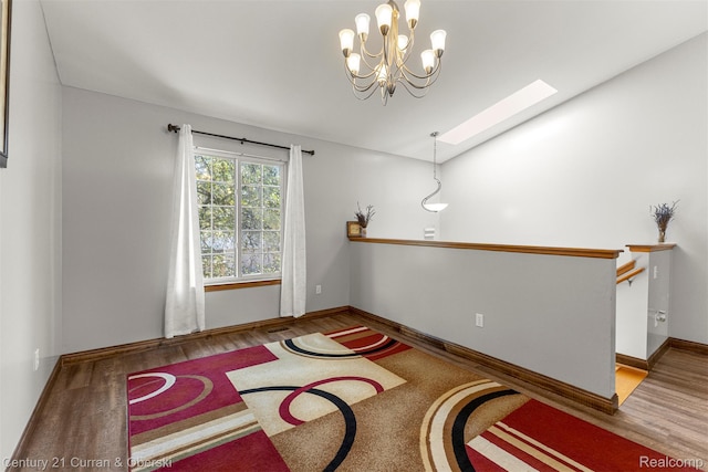 1786 Daisy Ln, Westland, MI 48186 - unfurnished room featuring a skylight, wood finished floors, and a chandelier