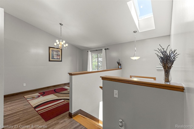 1786 Daisy Ln, Westland, MI 48186 - stairs with lofted ceiling, a skylight, wood finished floors, and a chandelier