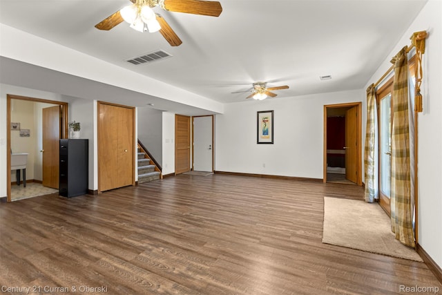 1786 Daisy Ln, Westland, MI 48186 - unfurnished living room featuring ceiling fan, stairway, and dark wood finished floors