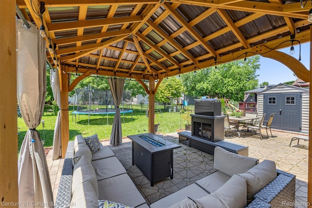 1786 Daisy Ln, Westland, MI 48186 - view of patio featuring a trampoline, outdoor lounge area, a gazebo, a storage shed, and outdoor dining space
