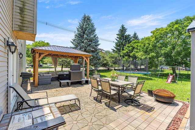 1786 Daisy Ln, Westland, MI 48186 - view of patio / terrace with a trampoline, a gazebo, a fire pit, a playground, and outdoor dining area