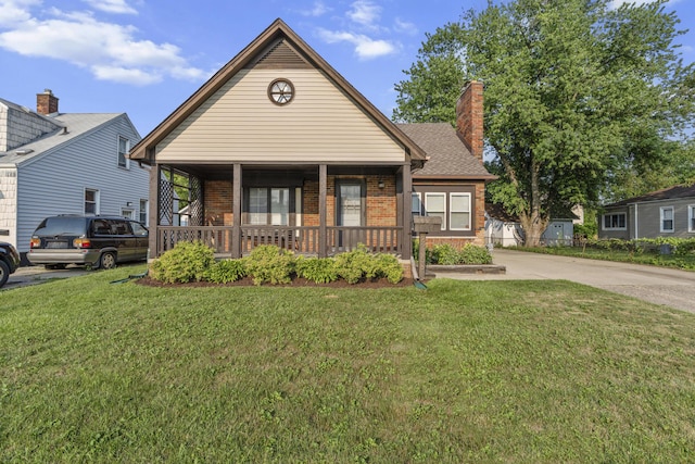 22358 Firwood Ave, Eastpointe, MI 48021 - view of front facade featuring a porch, brick siding, a front yard, driveway, and a chimney