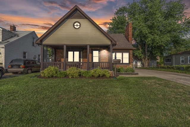 22358 Firwood Ave, Eastpointe, MI 48021 - view of front of property featuring a porch, brick siding, a front yard, and concrete driveway