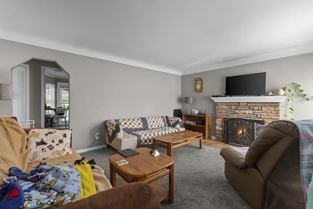 22358 Firwood Ave, Eastpointe, MI 48021 - living room with arched walkways, carpet floors, and a stone fireplace