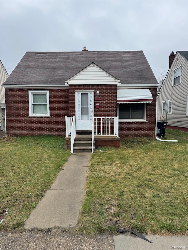 8116 Wyoming St, Detroit, MI 48204 - view of front of home featuring brick siding, a front lawn, and a shingled roof