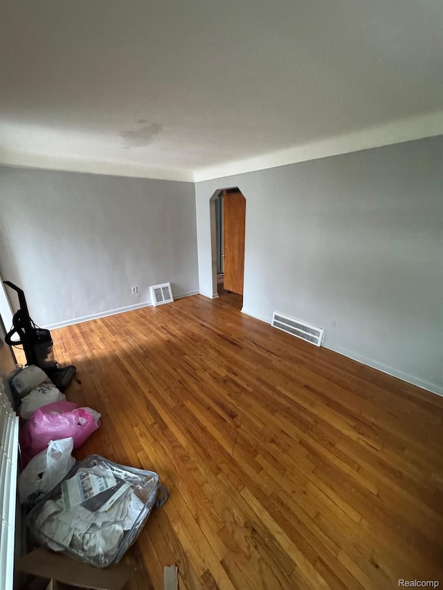 8116 Wyoming St, Detroit, MI 48204 - unfurnished living room featuring arched walkways and hardwood / wood-style flooring