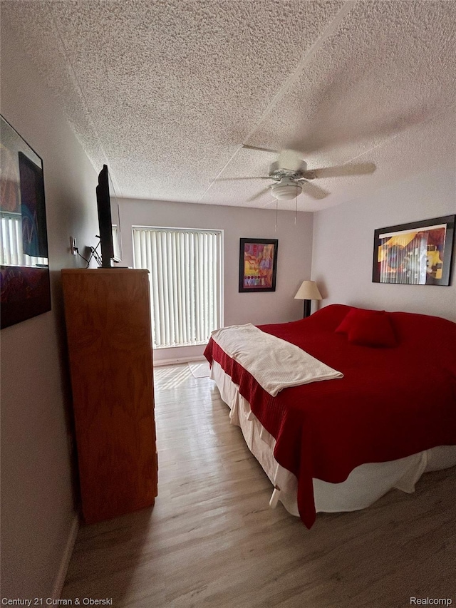 21800 Morley Ave Unit 607, Dearborn, MI 48124 - bedroom with wood finished floors, a ceiling fan, and a textured ceiling