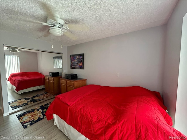 21800 Morley Ave Unit 607, Dearborn, MI 48124 - bedroom featuring wood finished floors, a textured ceiling, a closet, and ceiling fan