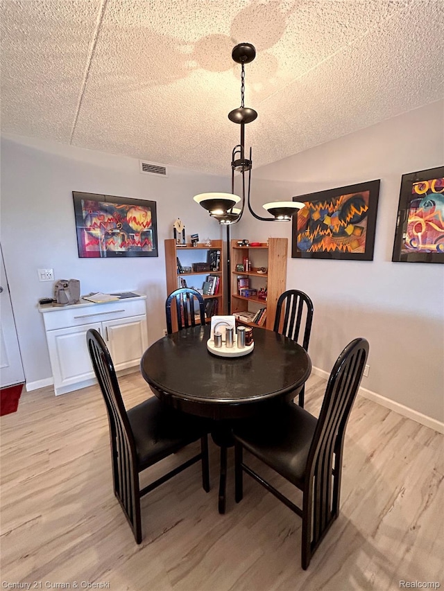 21800 Morley Ave Unit 607, Dearborn, MI 48124 - dining room featuring light wood finished floors and a textured ceiling