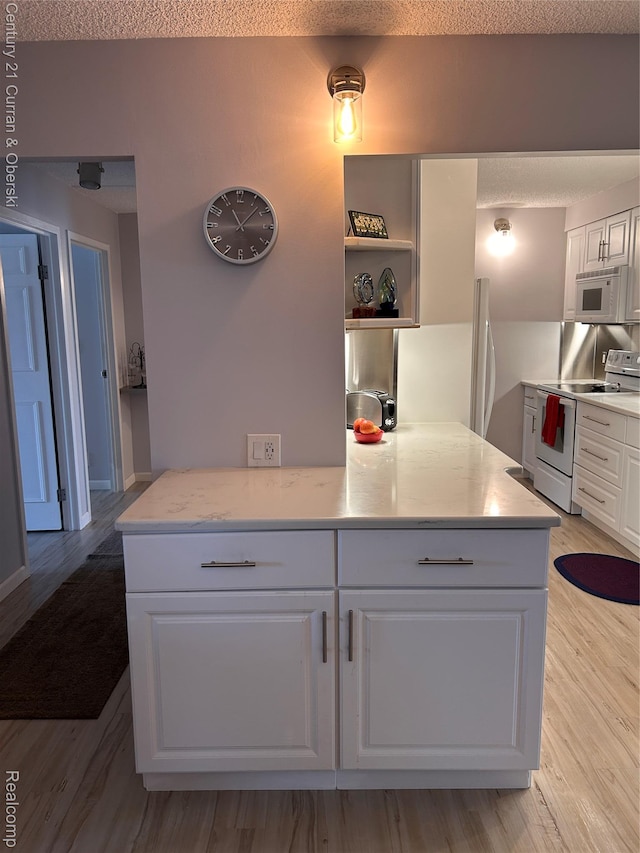 21800 Morley Ave Unit 607, Dearborn, MI 48124 - kitchen featuring white appliances, white cabinetry, a textured ceiling, light wood-type flooring, and open shelves