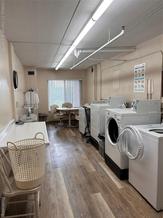 21800 Morley Ave Unit 607, Dearborn, MI 48124 - shared laundry featuring separate washer and dryer, wood finished floors, and concrete block wall