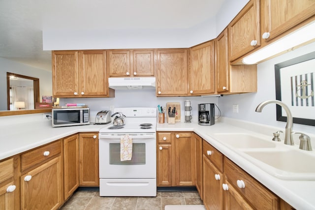 5015 Main St, Onekama, MI 49675 - kitchen with white range with electric cooktop, stainless steel microwave, under cabinet range hood, and light countertops