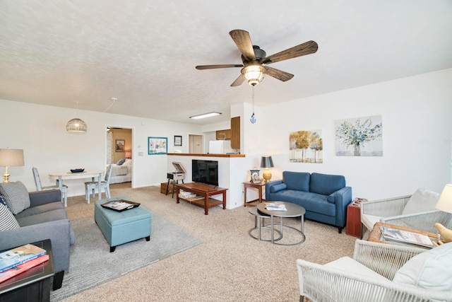 5015 Main St, Onekama, MI 49675 - living area featuring carpet flooring and a ceiling fan