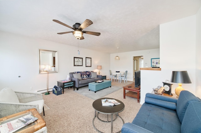 5015 Main St, Onekama, MI 49675 - carpeted living room featuring a baseboard heating unit and a ceiling fan
