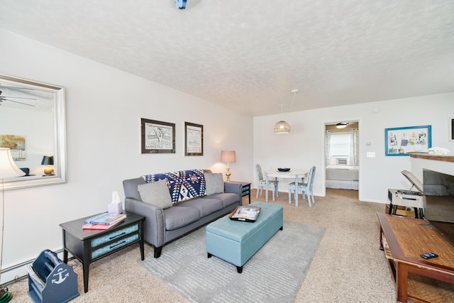 5015 Main St, Onekama, MI 49675 - living room featuring a textured ceiling, carpet, a ceiling fan, and baseboard heating