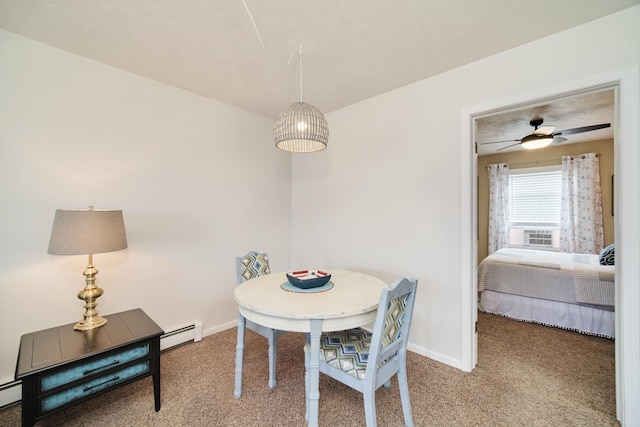 5015 Main St, Onekama, MI 49675 - dining area with carpet floors, a baseboard radiator, baseboard heating, and a ceiling fan