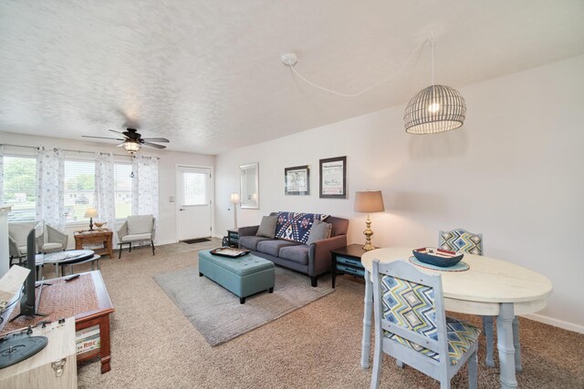 5015 Main St, Onekama, MI 49675 - carpeted living room featuring a ceiling fan and baseboards