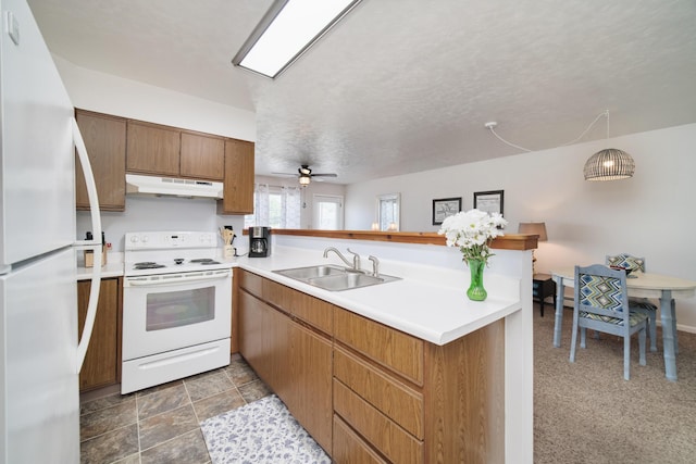 5015 Main St, Onekama, MI 49675 - kitchen featuring white appliances, under cabinet range hood, a peninsula, and light countertops
