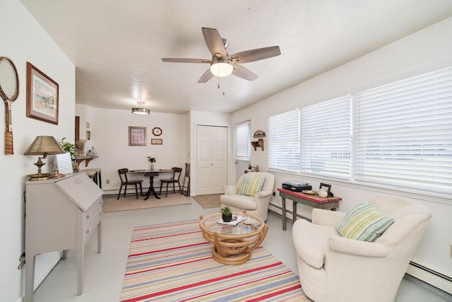 5015 Main St, Onekama, MI 49675 - living room with a baseboard radiator and a ceiling fan