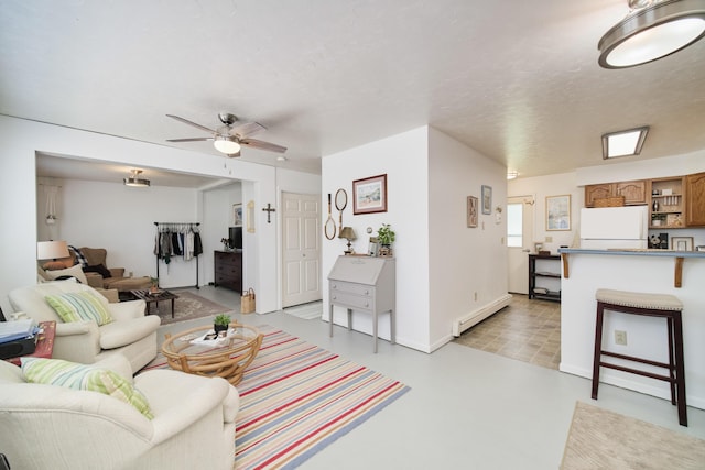 5015 Main St, Onekama, MI 49675 - living room with baseboard heating and ceiling fan
