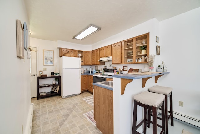 5015 Main St, Onekama, MI 49675 - kitchen featuring white appliances, open shelves, brown cabinets, a peninsula, and under cabinet range hood
