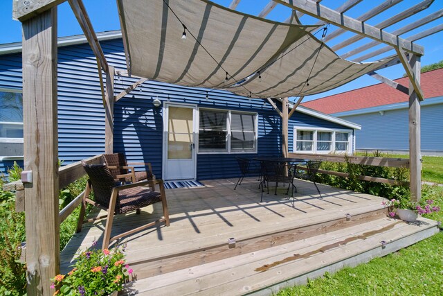 5015 Main St, Onekama, MI 49675 - wooden terrace with a pergola and outdoor dining space