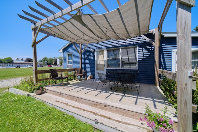5015 Main St, Onekama, MI 49675 - wooden deck with outdoor dining area, a pergola, and a yard