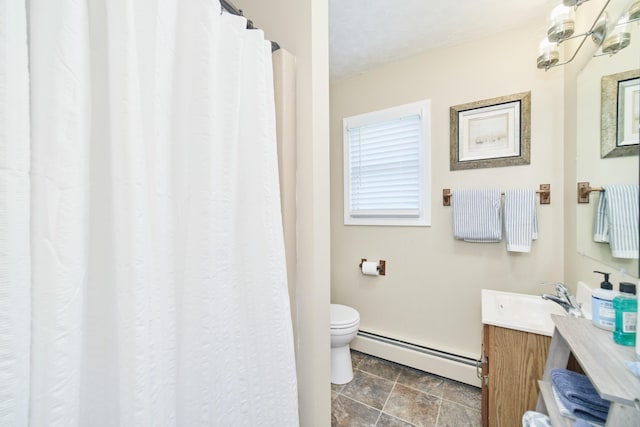 5015 Main St, Onekama, MI 49675 - bathroom featuring a baseboard radiator, vanity, and stone finish flooring