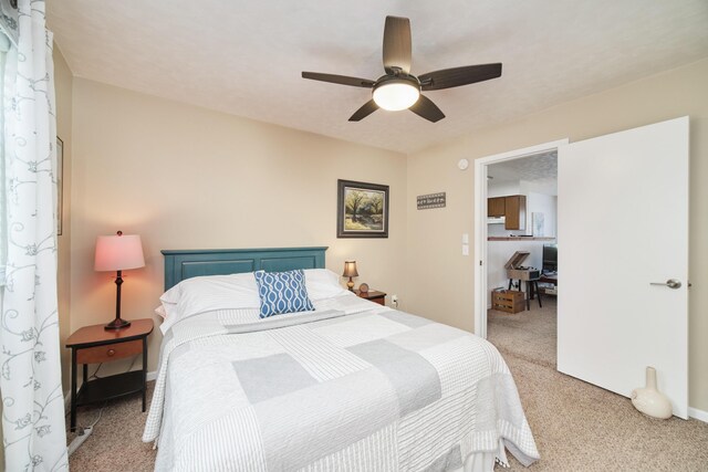 5015 Main St, Onekama, MI 49675 - bedroom with light carpet, ceiling fan, and a desk