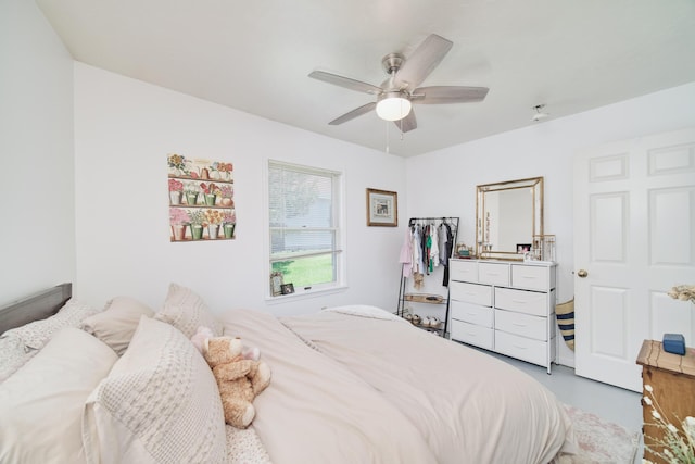 5015 Main St, Onekama, MI 49675 - bedroom with ceiling fan and finished concrete floors