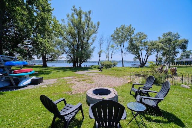 5015 Main St, Onekama, MI 49675 - view of grassy yard with an outdoor fire pit and a water view