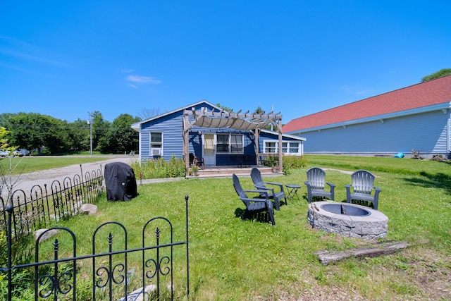 5015 Main St, Onekama, MI 49675 - rear view of property featuring a fire pit, a pergola, a lawn, and a patio area