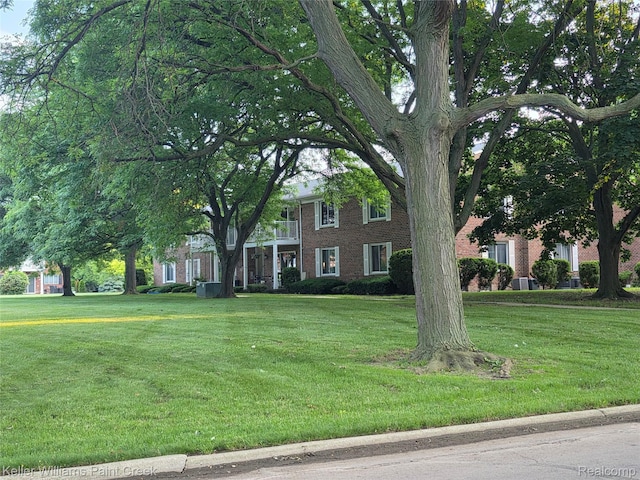 42231 Toddmark Ln, Clinton Township, MI 48038 - view of front of home with brick siding, a front yard, and a balcony