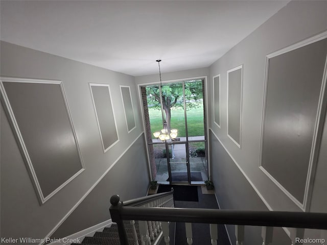 42231 Toddmark Ln, Clinton Township, MI 48038 - stairway featuring a chandelier and baseboards