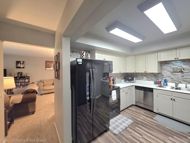42231 Toddmark Ln, Clinton Township, MI 48038 - kitchen featuring black appliances, light countertops, open floor plan, backsplash, and white cabinets