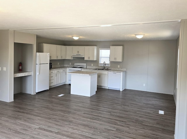 26 Traveler Dr Unit 26, Sparta, MI 49345 - kitchen featuring white appliances, white cabinets, dark wood-style flooring, a kitchen island, and under cabinet range hood