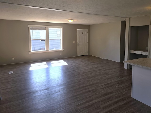 26 Traveler Dr Unit 26, Sparta, MI 49345 - unfurnished room with dark wood-type flooring and a textured ceiling