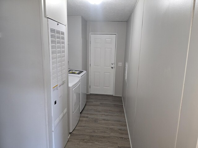 26 Traveler Dr Unit 26, Sparta, MI 49345 - laundry area featuring washer and dryer, dark wood-style flooring, a textured ceiling, and a heating unit