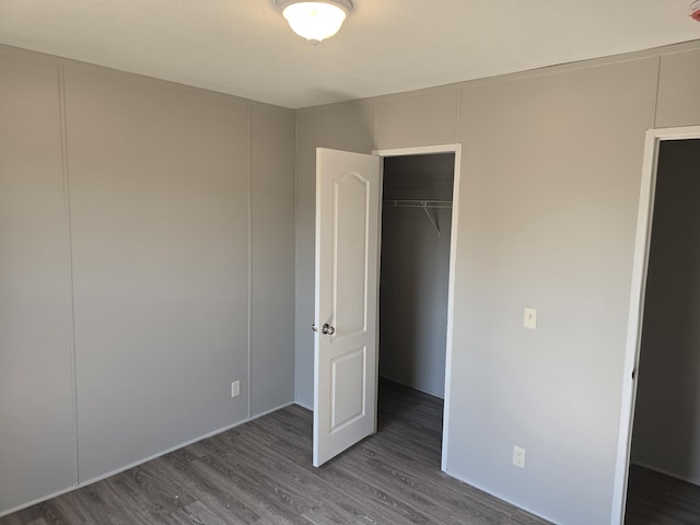 26 Traveler Dr Unit 26, Sparta, MI 49345 - unfurnished bedroom featuring wood finished floors and a closet