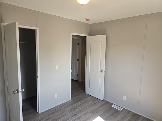 26 Traveler Dr Unit 26, Sparta, MI 49345 - unfurnished bedroom featuring wood finished floors and a closet