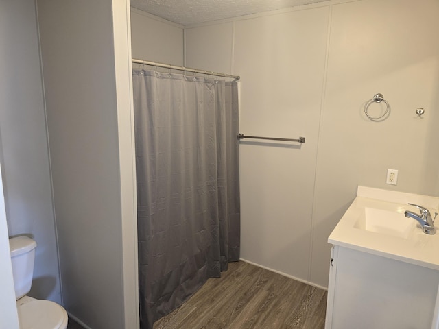 26 Traveler Dr Unit 26, Sparta, MI 49345 - bathroom with wood finished floors, vanity, a textured ceiling, and a shower with shower curtain