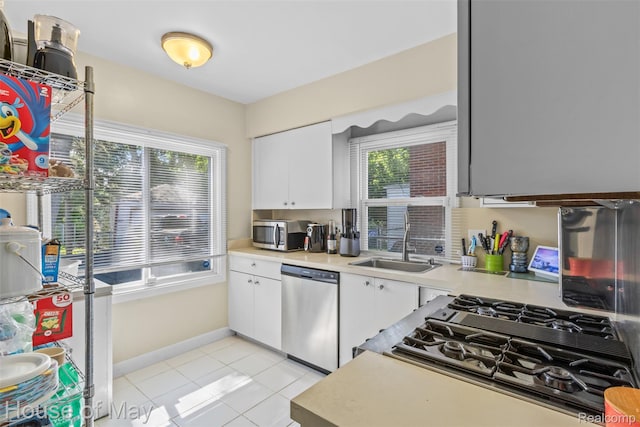 16842 Greenview Ave, Detroit, MI 48219 - kitchen featuring stainless steel appliances, light countertops, white cabinetry, and light tile patterned floors